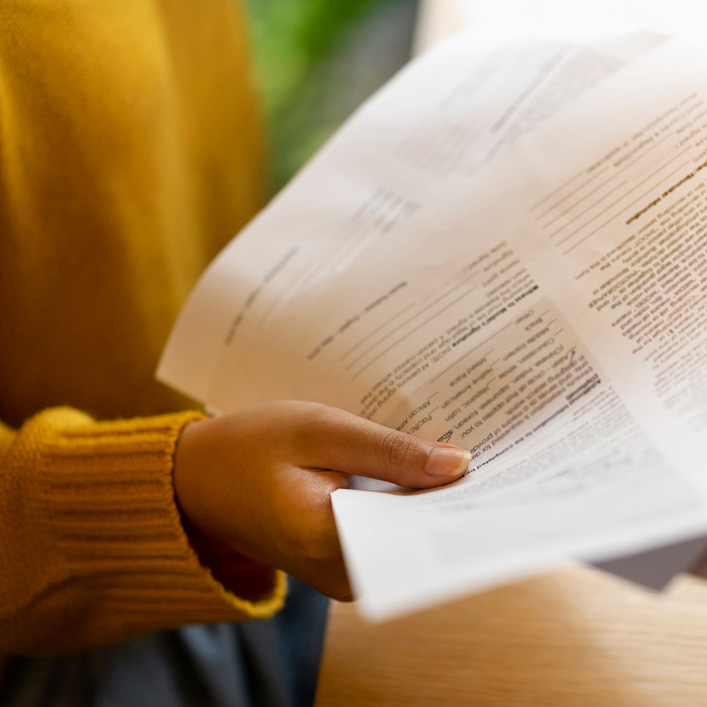 a women hand holding some papers 