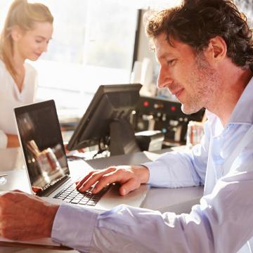 man sitting in front of a laptop